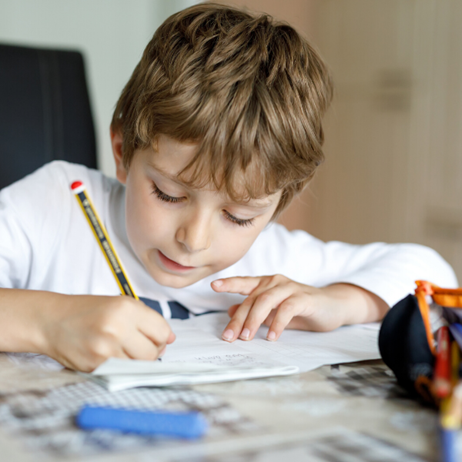 boy writing on paper