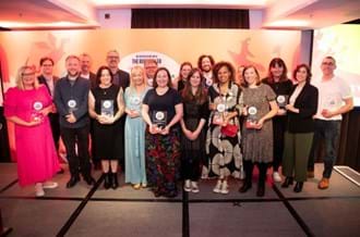 The winners of The Week Junior Book Awards 2025, holding their trophies and smiling at the camera