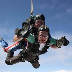 A young man skydiving with an instructor