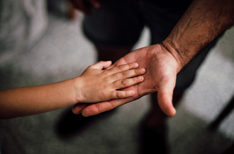 hands of a parent and child