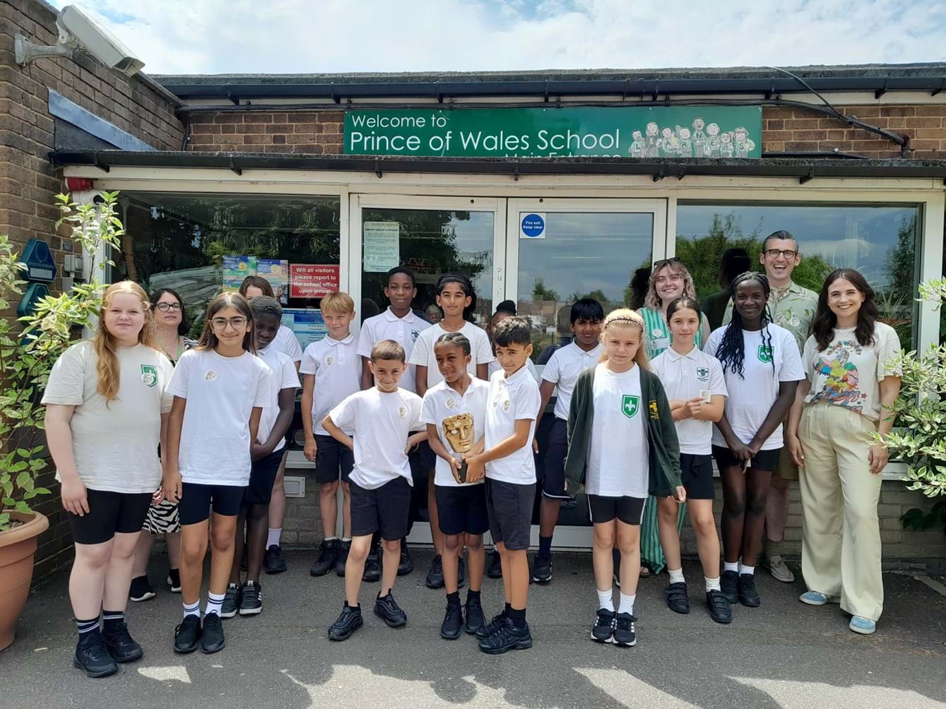 Students holding a BAFTA award with special talents