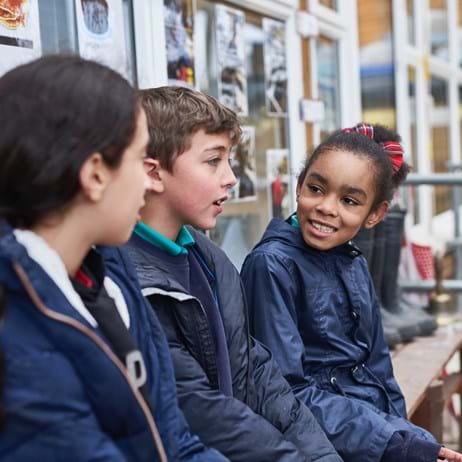 Three children talking in playground