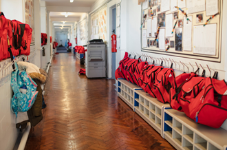 a school hallways with numerous backpacks