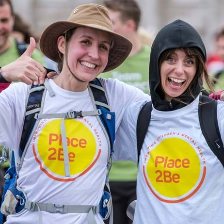 Two women with their thumbs-up during a fundraising event