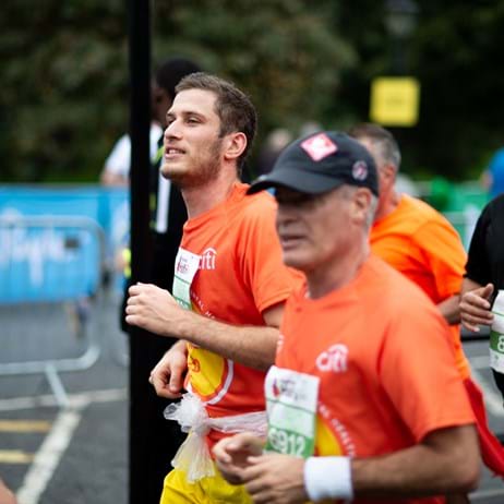 Two men running in Place2Be tops