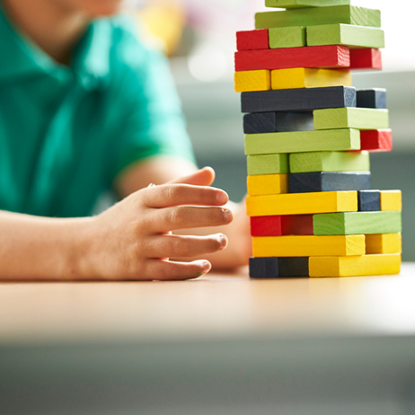 Child playing with jenga blocks