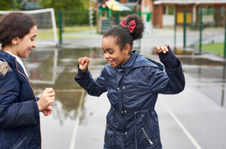 Two girls playing on playground