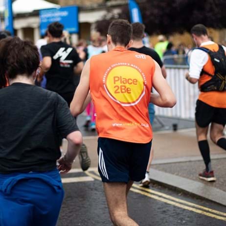 Person running in crowd for Place2Be