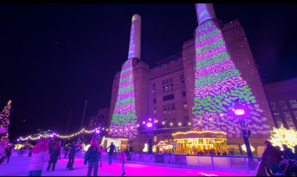 Battersea Power Station's ice skating rink. The power station is covered in Christmas lights.