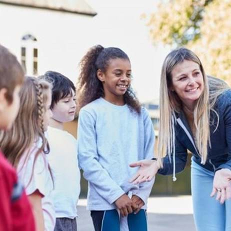 youth leader talking to children outside