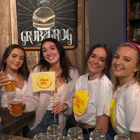 Student supporters in pub with Place2Be flags