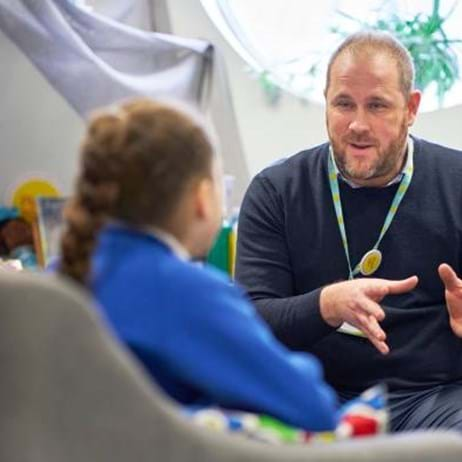 school counsellor sat with child in Place2Be therapy room