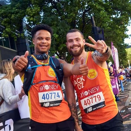 two young men in Place2Be running vests