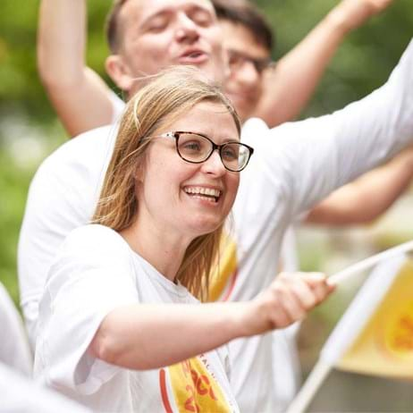 person cheering on runners