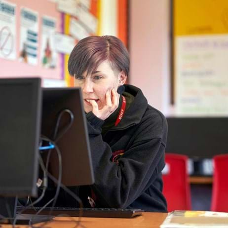 person at desk on computer