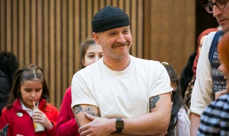 Ricky Martin smiling and laughing with pupils and teachers.