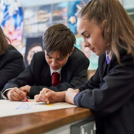 children colouring at classroom desk