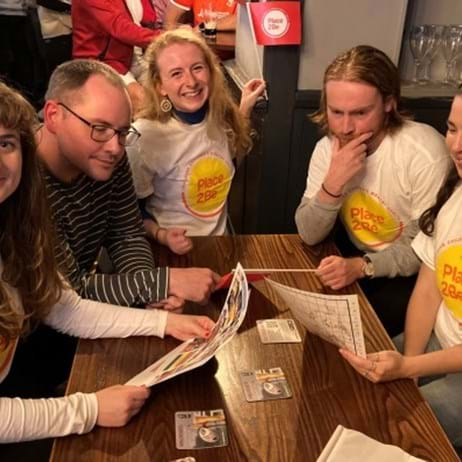 team taking part in a pub quiz fundraising for Place2Be and wearing Place2Be T-shirts