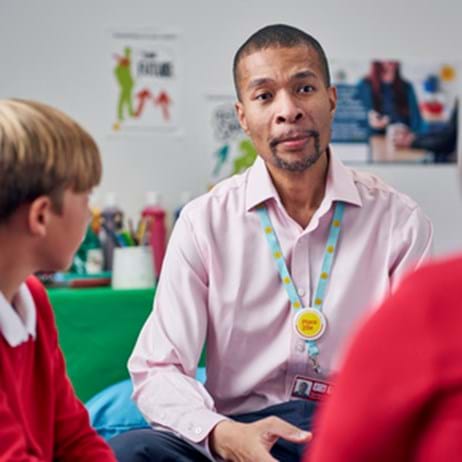 child counsellor with two children in therapy room