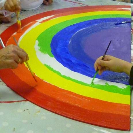 Children painting rainbow