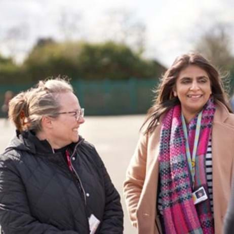 three staff members chatting in school playground