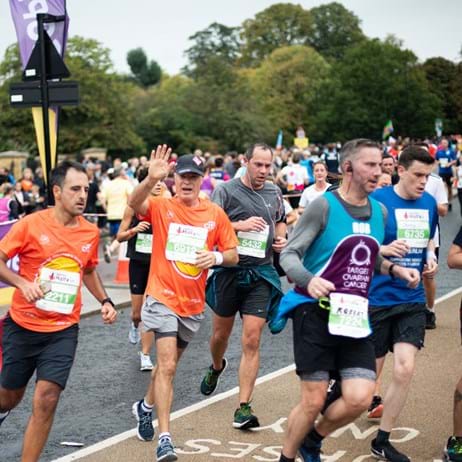 Place2Be and other runners, one waving